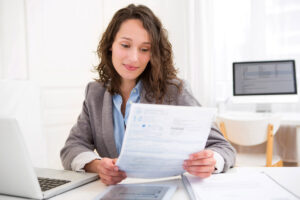 woman looking a documents durning long term care insurance in Elizabeth 